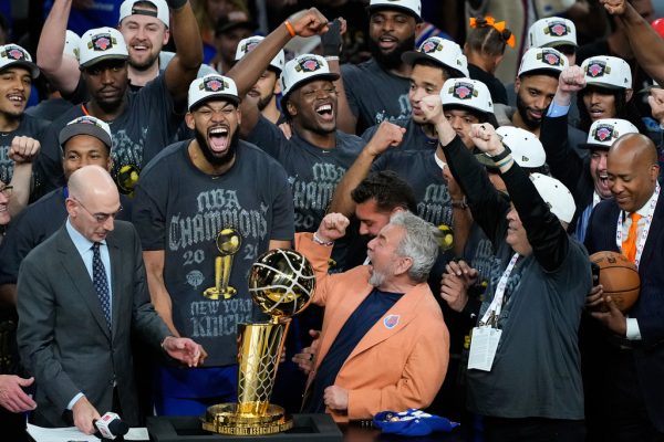 The New York Knicks celebrate with the Larry O'Brien Championship Trophy after defeating the San Antonio Spurs in Game 5 of the NBA Finals basketball series, Saturday, June 13, 2026, in San Antonio. (AP Photo/Ross D. Franklin)