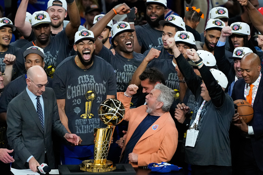 The New York Knicks celebrate with the Larry O'Brien Championship Trophy after defeating the San Antonio Spurs in Game 5 of the NBA Finals basketball series, Saturday, June 13, 2026, in San Antonio. (AP Photo/Ross D. Franklin)