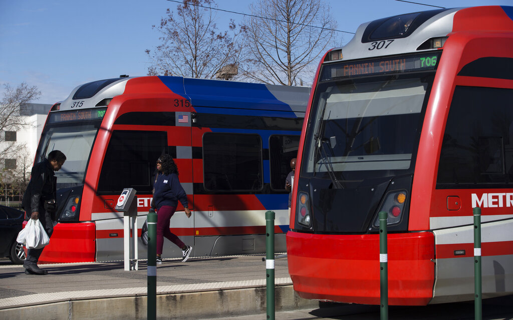 In this Thursday, Jan. 10, 2019 photo, passengers get on and off a METRO Rail Red Line train at Houston Community College Northline Campus in Houston. The Houston Chronicle reports Metropolitan Transit Authority officials are still tweaking the agency’s long-range plan that’s estimated to start with $7.5 billion in improvements for developing 66 miles of bus rapid transit and at least 16 additional miles of light rail.  (Yi-Chin Lee/Houston Chronicle via AP)